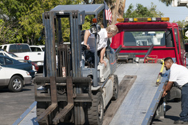flatbed transporting a fork lift